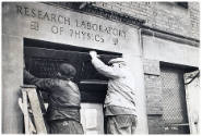 workmen removing part of the door frame of the Cruft Laboratory in order to bring in crates con…