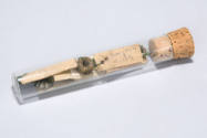 six spools of chrome wire in a stoppered glass test tube