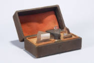boxed set of prisms and a lens
