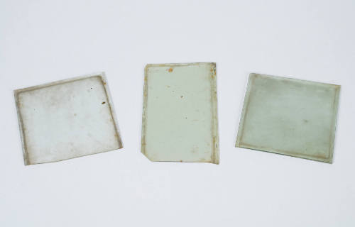three pieces of old window glass